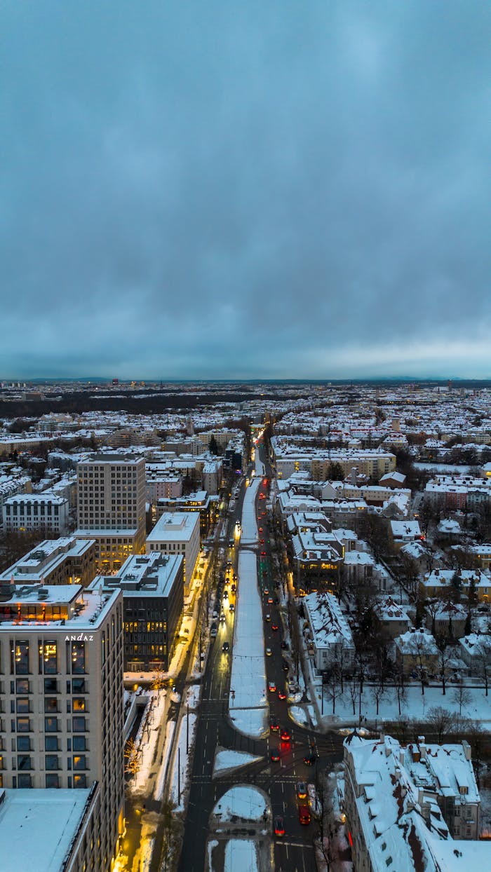 services-01 A stunning aerial view of Munich in winter, showcasing a snow-covered cityscape at dusk.
